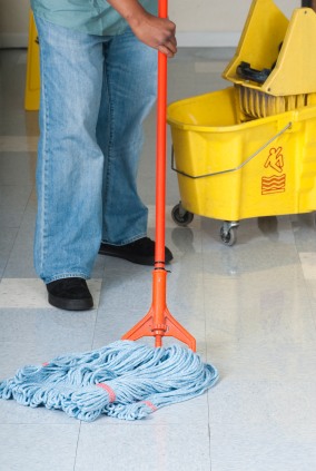 DJ's Cleaning LLC janitor in Kettering, MD mopping floor.